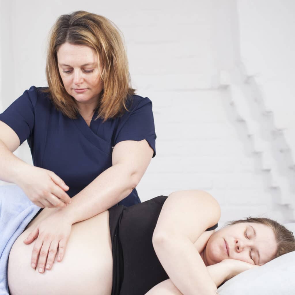 Sam Colverd carrying out pregnancy massage